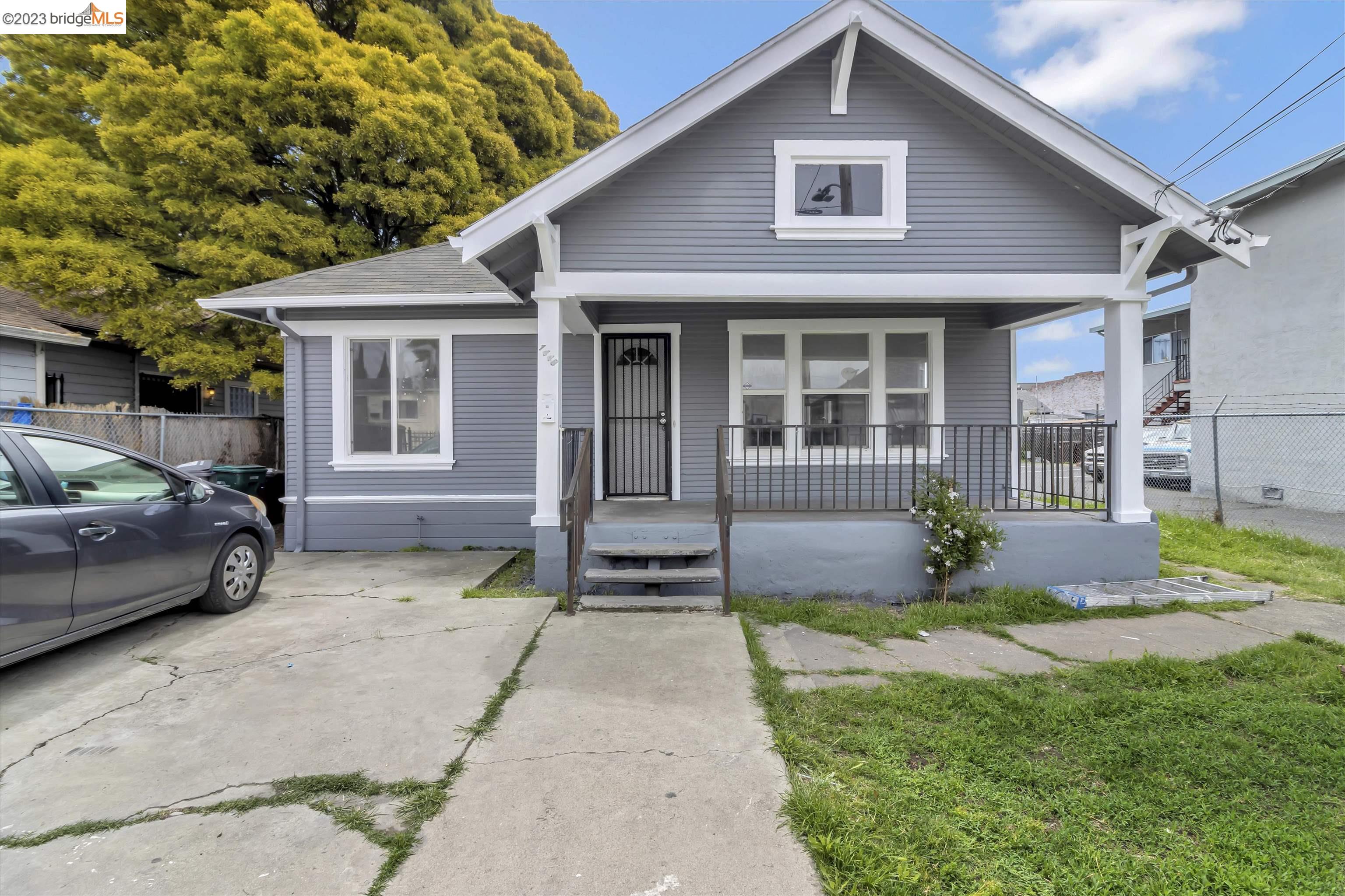1448 71st Avenue Oakland, CA 94621 - Photo 1 of 1 a front view of a house with a garden and porch