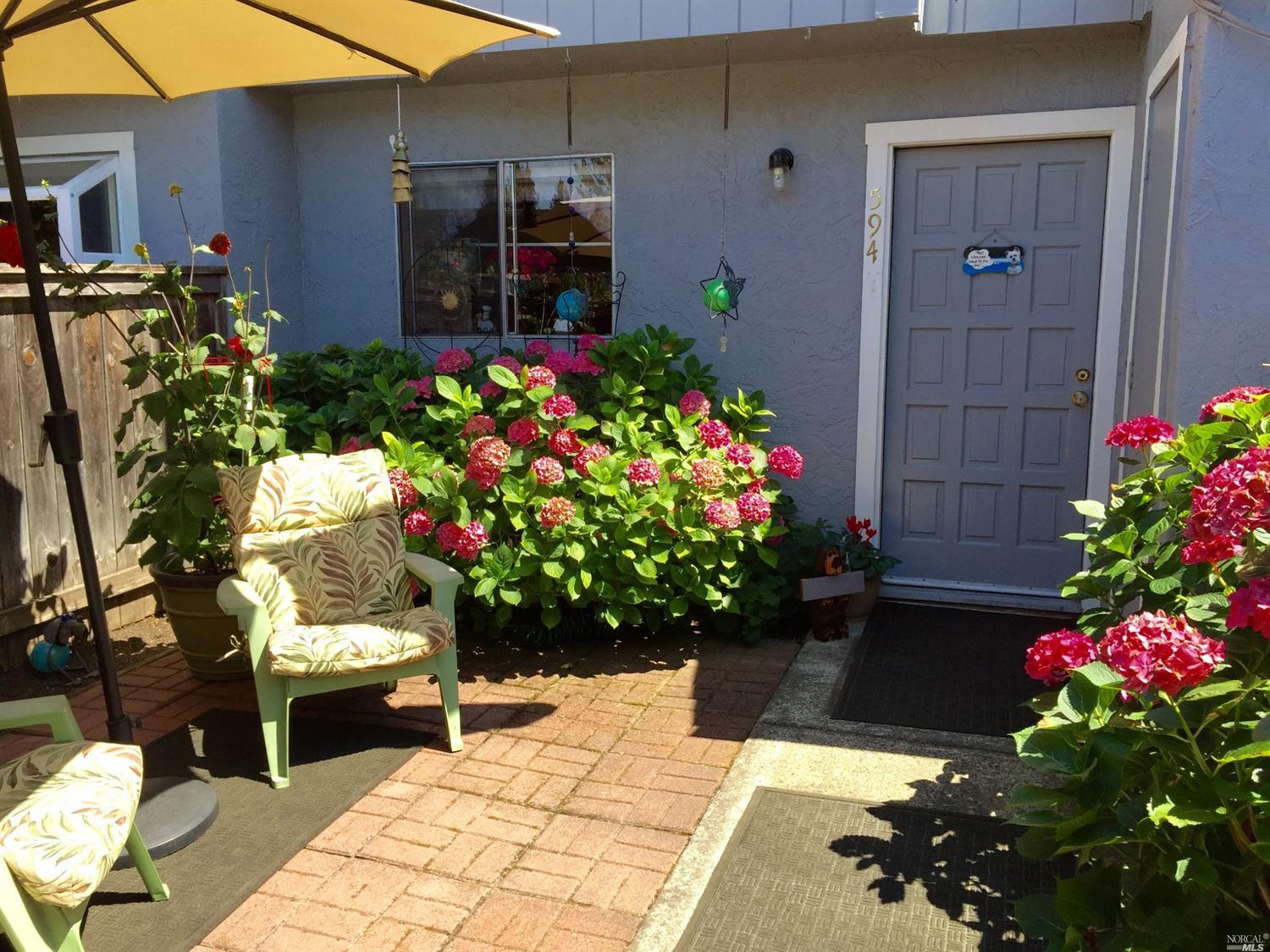 594 Racquet Club Circle Rohnert Park, CA 94928 - Photo 1 of 1 a flower garden with flowers and wooden fence