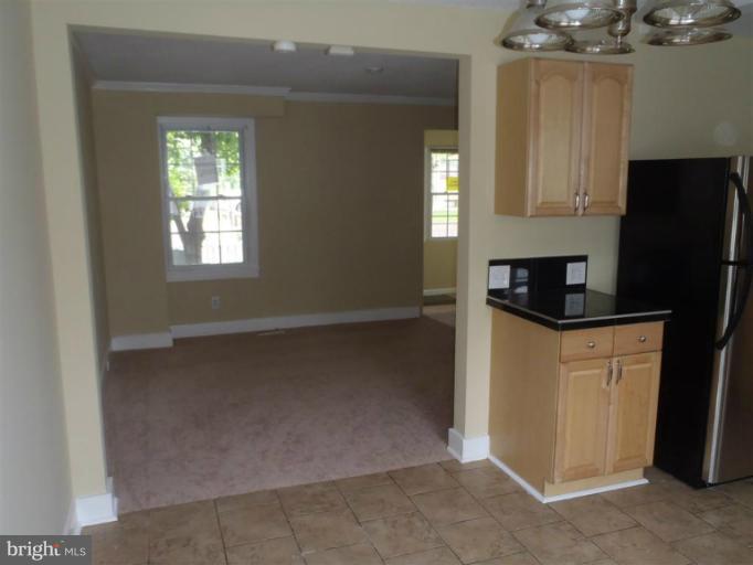 26 Midship Road Dundalk, MD 21222 - Photo 8 of 30 a kitchen with granite countertop white cabinets and refrigerator