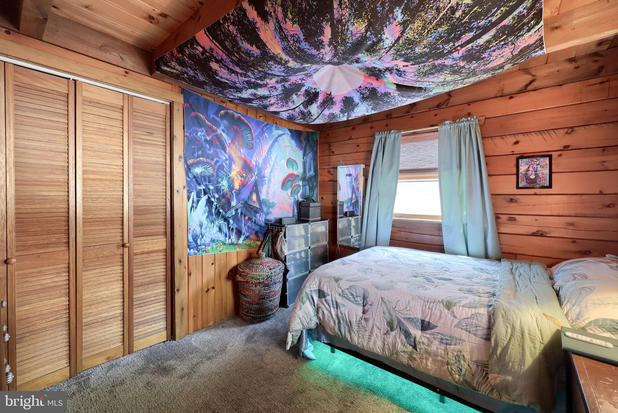 149 Douts Hill Road Holtwood, PA 17532 - Photo 21 of 77 a bedroom with a large bed and a chandelier