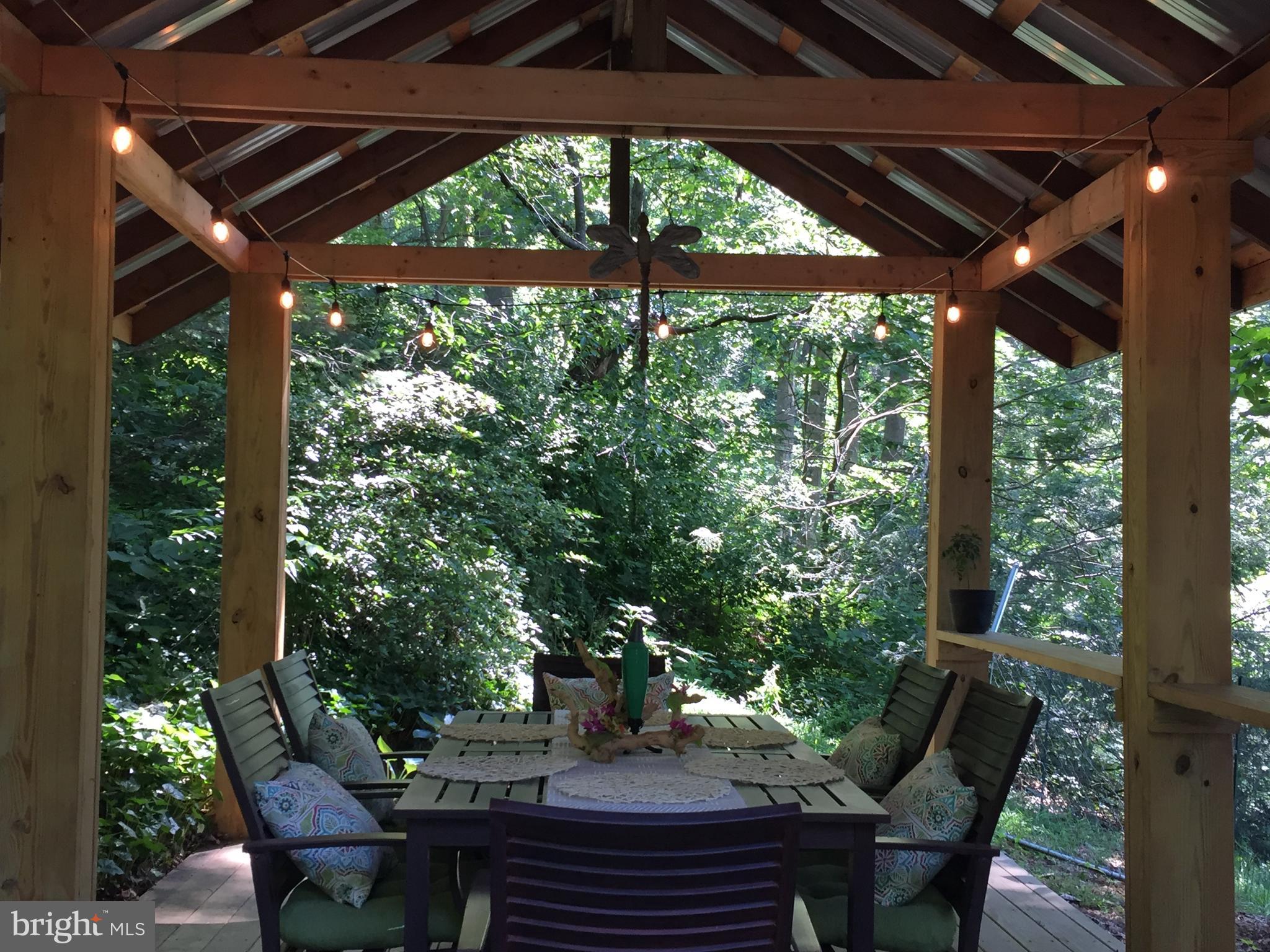 149 Douts Hill Road Holtwood, PA 17532 - Photo 54 of 77 a view of a patio with table and chairs under an umbrella