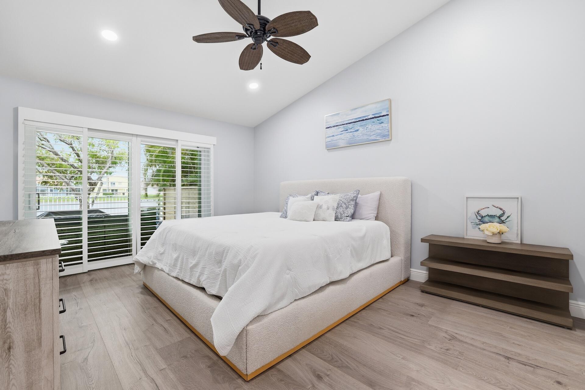 7403 Shell Ridge Terrace Lake Worth, FL 33467 - Photo 11 of 37 a large bed sitting in a bedroom next to a window