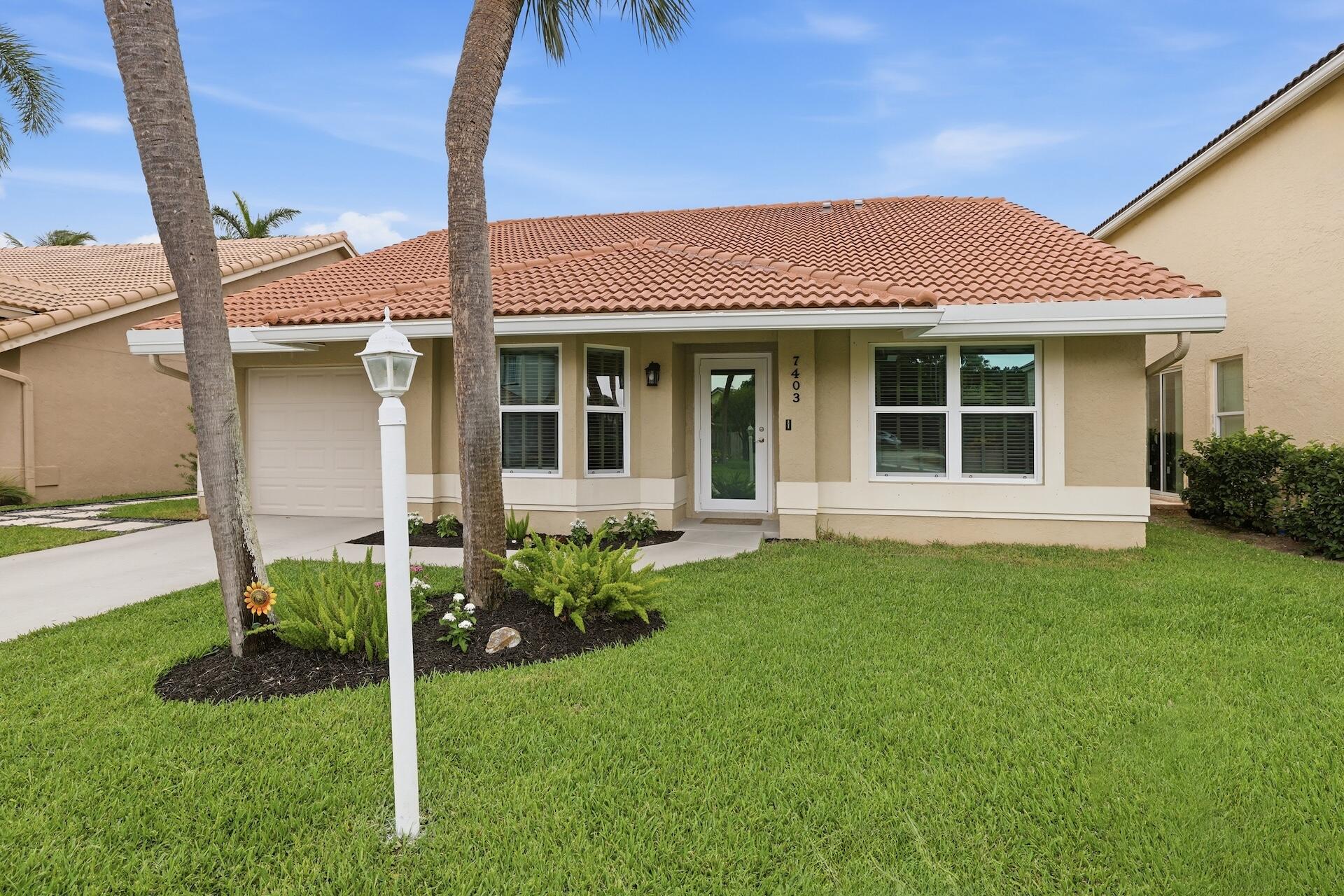 7403 Shell Ridge Terrace Lake Worth, FL 33467 - Photo 24 of 37 a view of a house with backyard and garden