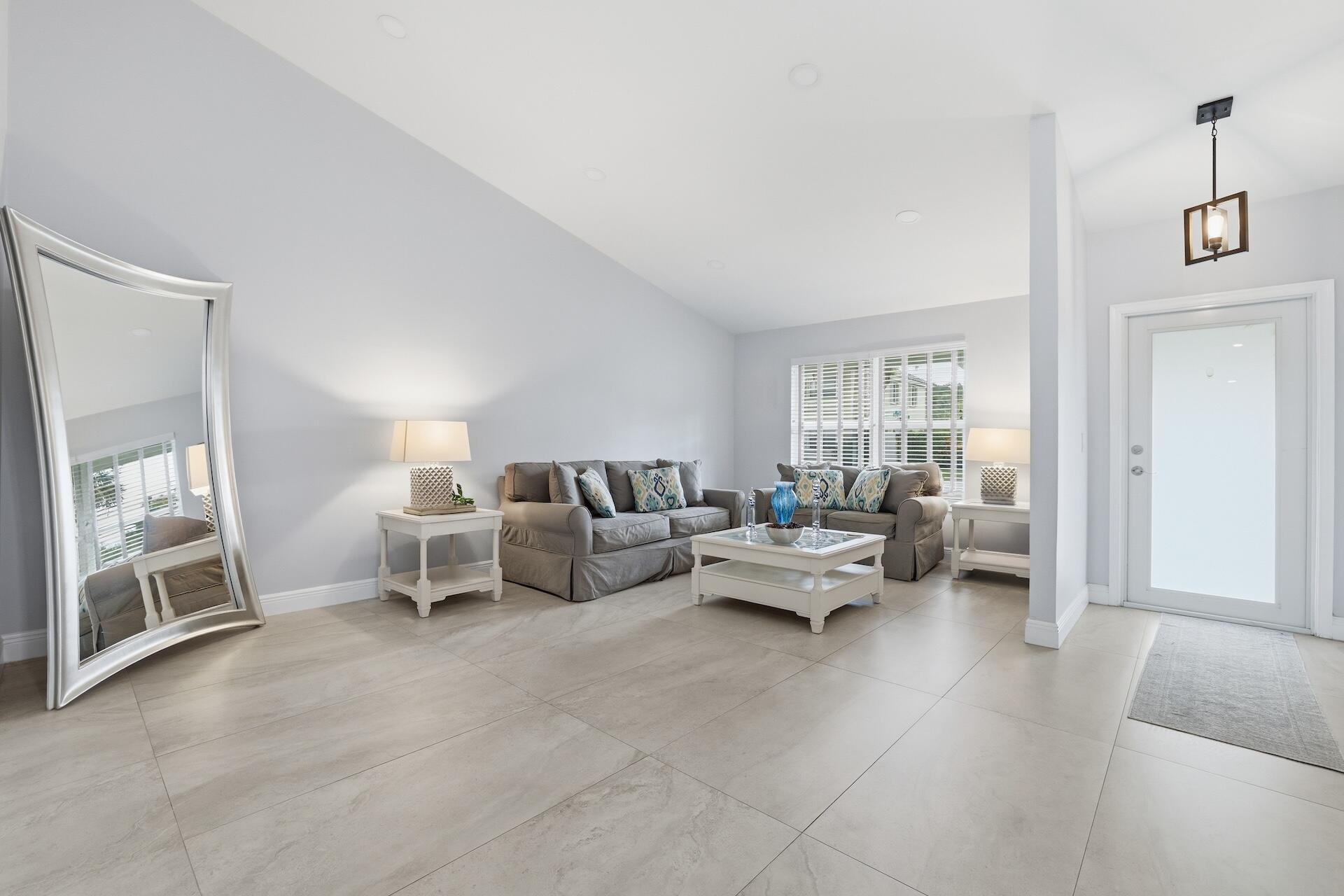 7403 Shell Ridge Terrace Lake Worth, FL 33467 - Photo 3 of 37 a living room with furniture and a window