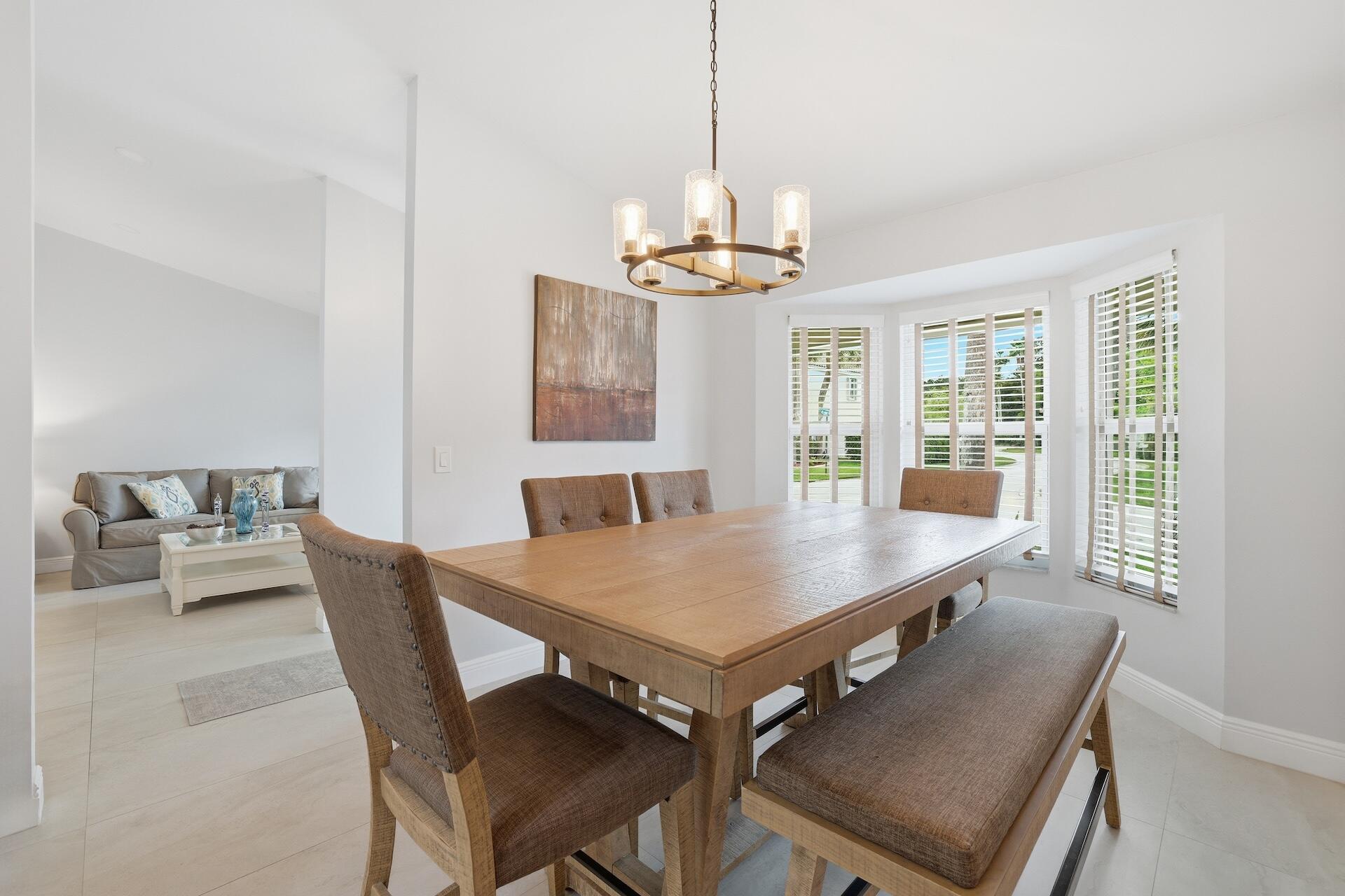 7403 Shell Ridge Terrace Lake Worth, FL 33467 - Photo 5 of 37 a view of a dining room with furniture window and wooden floor