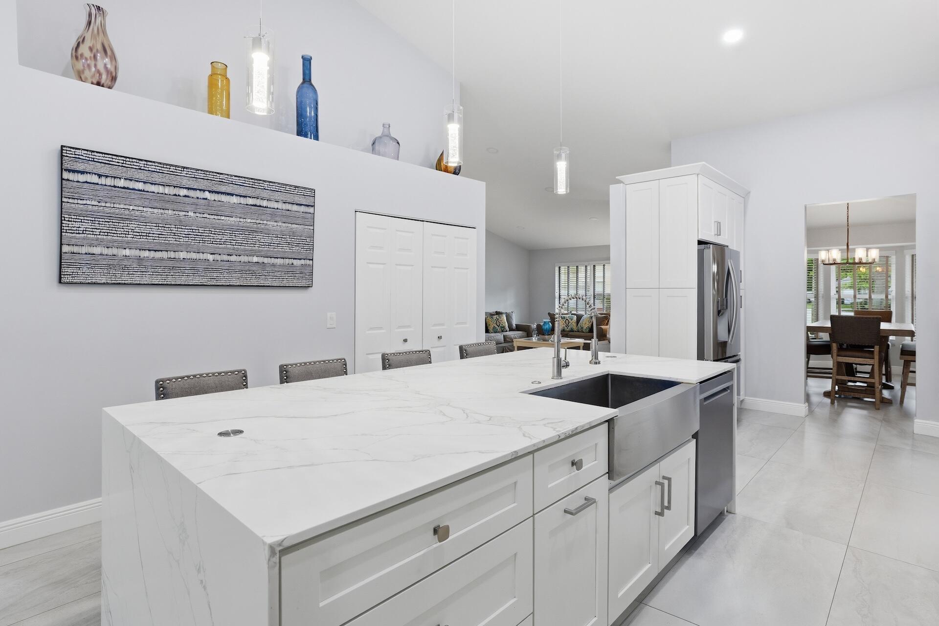 7403 Shell Ridge Terrace Lake Worth, FL 33467 - Photo 7 of 37 a kitchen with sink and chairs