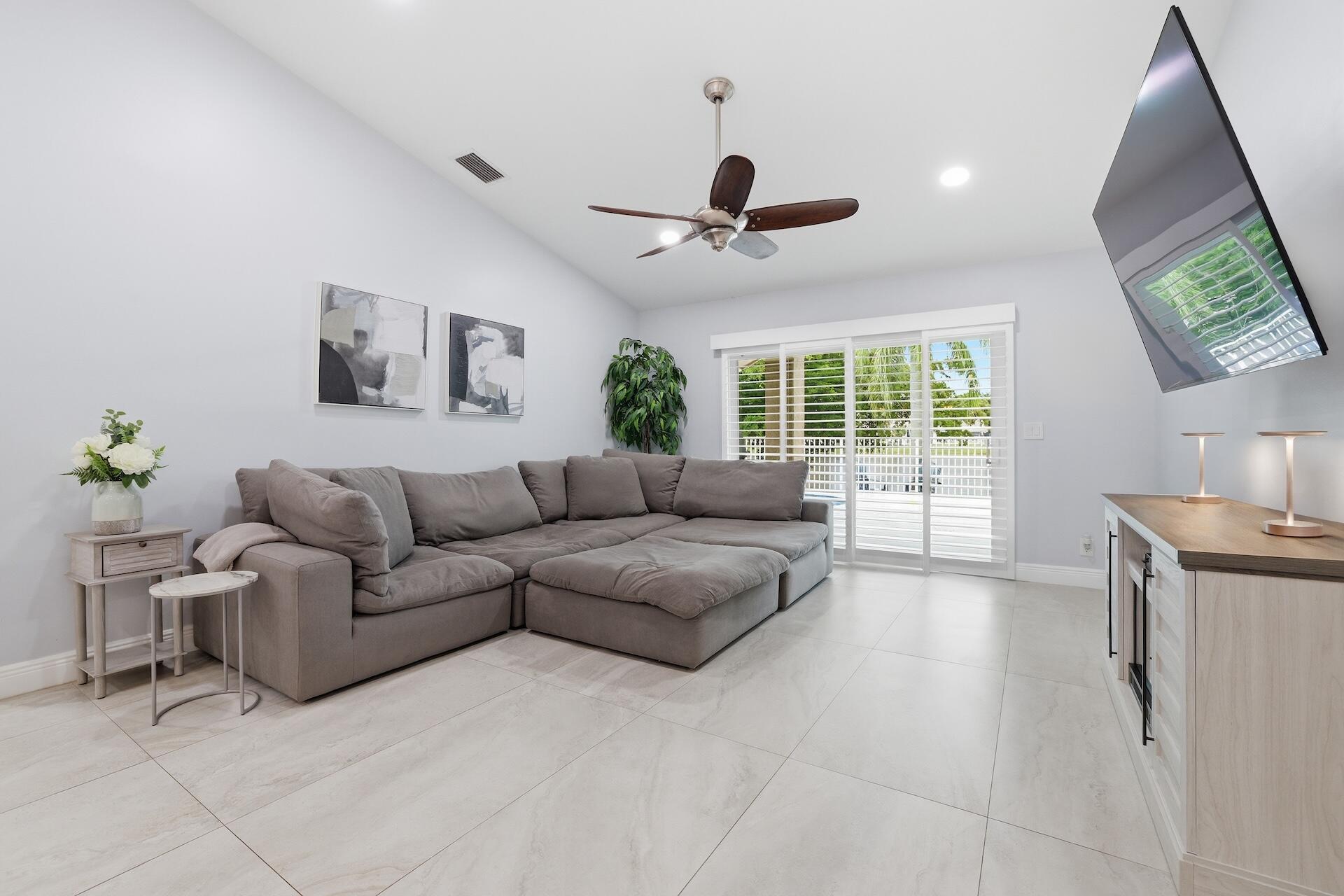 7403 Shell Ridge Terrace Lake Worth, FL 33467 - Photo 9 of 37 a living room with furniture and a flat screen tv