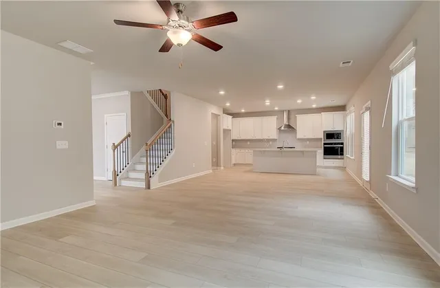 a view of kitchen with refrigerator and window