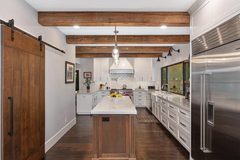 38318 Larue Way Davis, CA 95616 - Photo 22 of 92 a dining hall with stainless steel appliances kitchen island granite countertop a refrigerator and a stove top oven