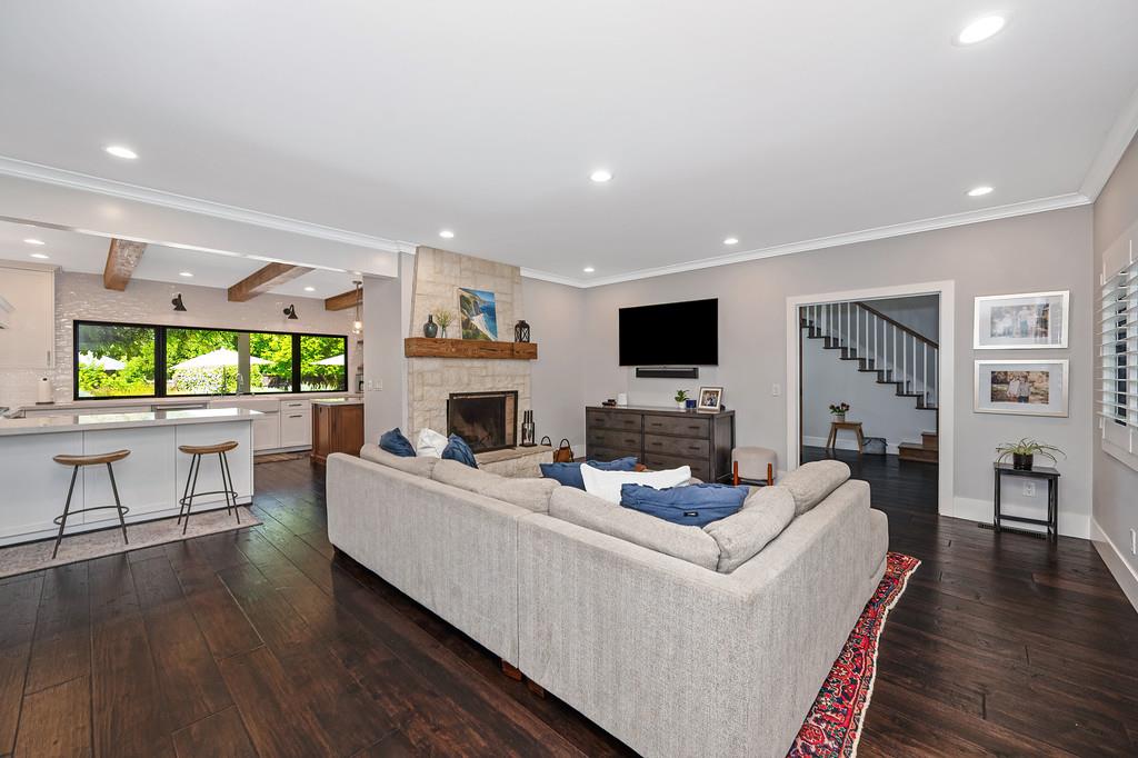 38318 Larue Way Davis, CA 95616 - Photo 33 of 92 a living room with furniture a fireplace and a flat screen tv