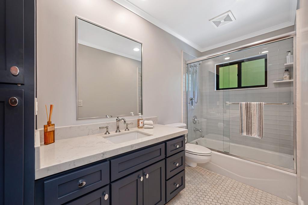 38318 Larue Way Davis, CA 95616 - Photo 35 of 92 a bathroom with a sink a large mirror and a bathtub