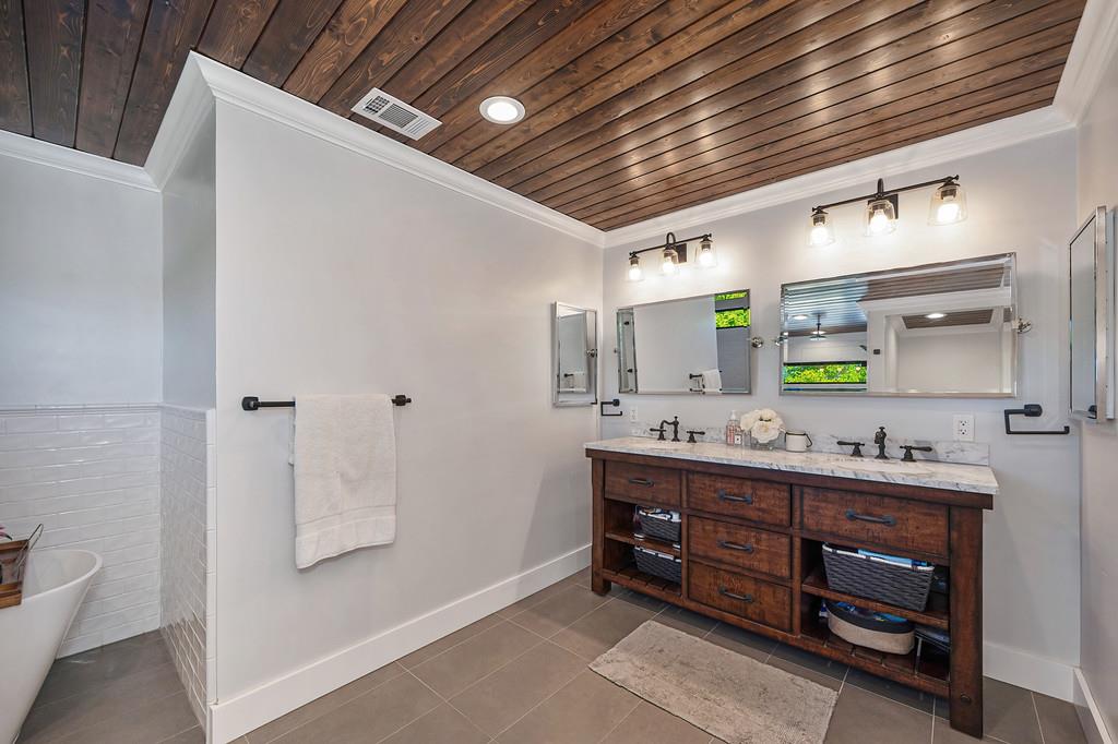 38318 Larue Way Davis, CA 95616 - Photo 56 of 92 a bathroom with a double vanity sink toilet and a mirror