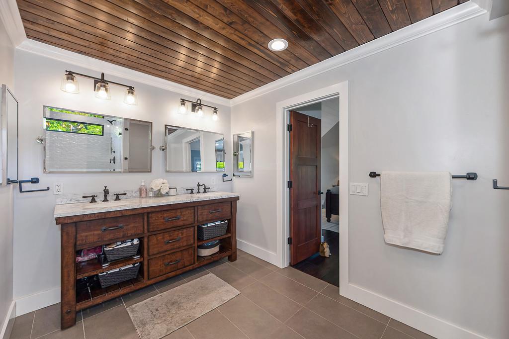 38318 Larue Way Davis, CA 95616 - Photo 57 of 92 a bathroom with a double vanity sink and a mirror