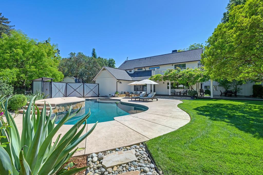 38318 Larue Way Davis, CA 95616 - Photo 68 of 92 a view of a patio with table and chairs potted plants and palm tree