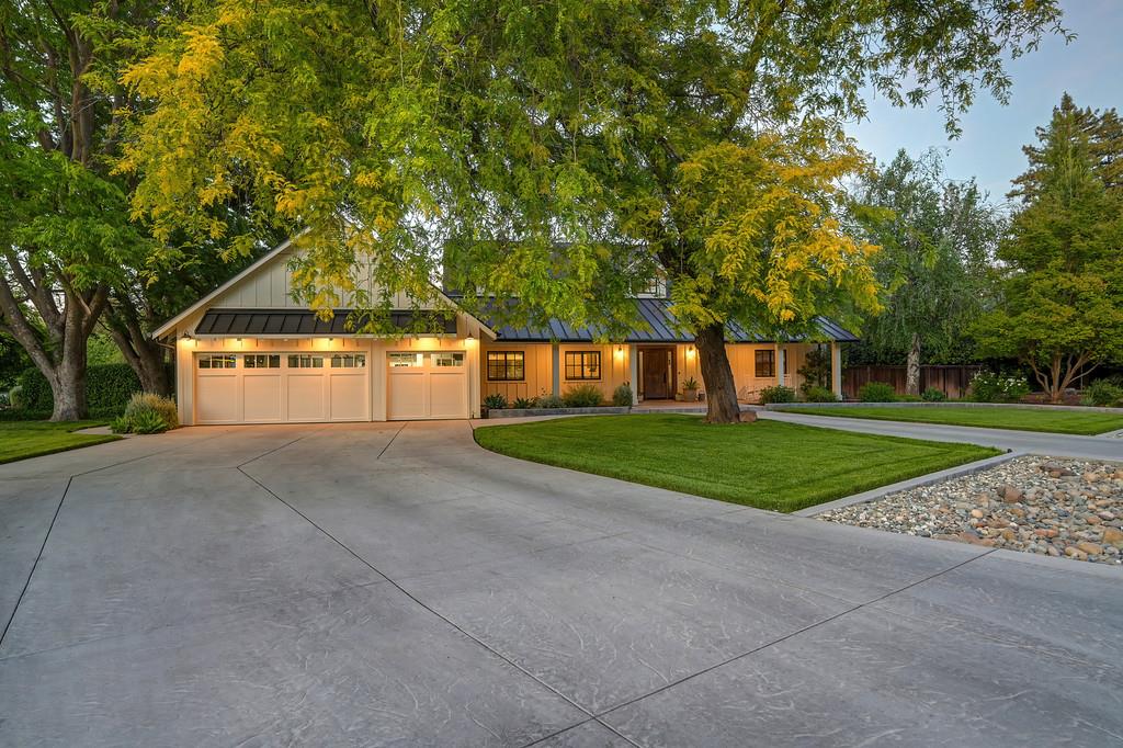 38318 Larue Way Davis, CA 95616 - Photo 8 of 92 a front view of a house with a yard and a garage