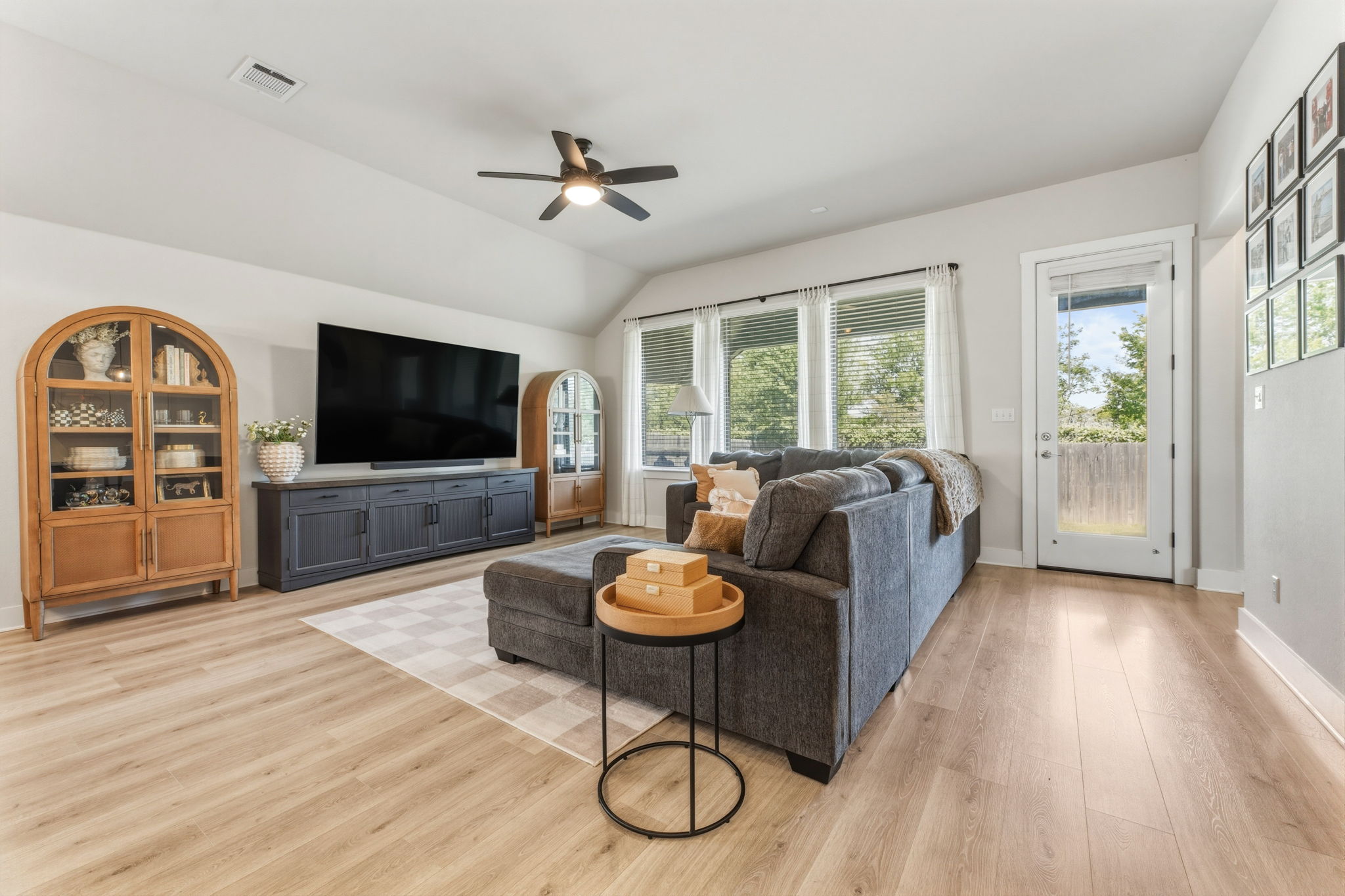 4505 Post Loop Round Rock, TX 78681 - Photo 11 of 40 Living area with light wood-type flooring, lofted ceiling, and ceiling fan