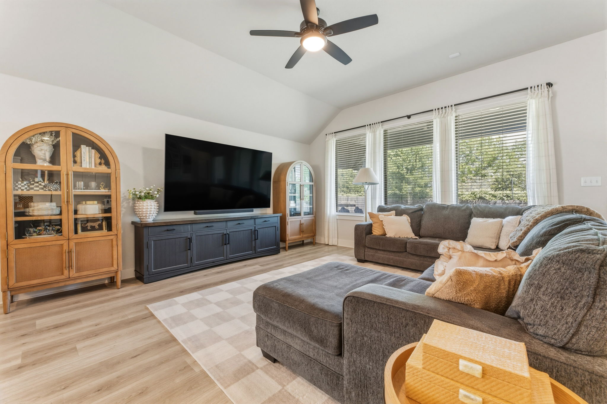 4505 Post Loop Round Rock, TX 78681 - Photo 12 of 40 Living room featuring a ceiling fan, light wood-style flooring, and vaulted ceiling