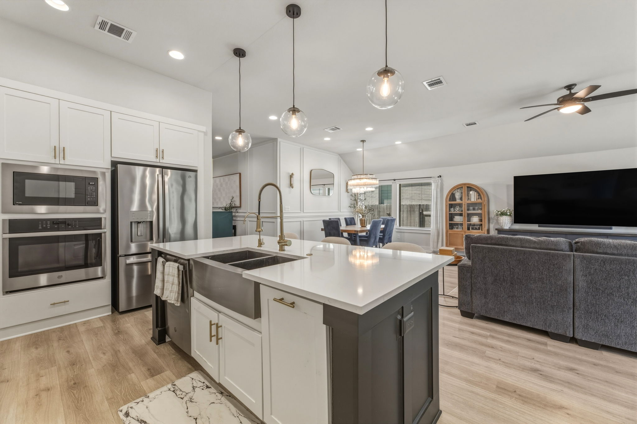4505 Post Loop Round Rock, TX 78681 - Photo 40 of 40 Kitchen featuring white cabinets, open floor plan, stainless steel appliances, a center island with sink, and pendant lighting