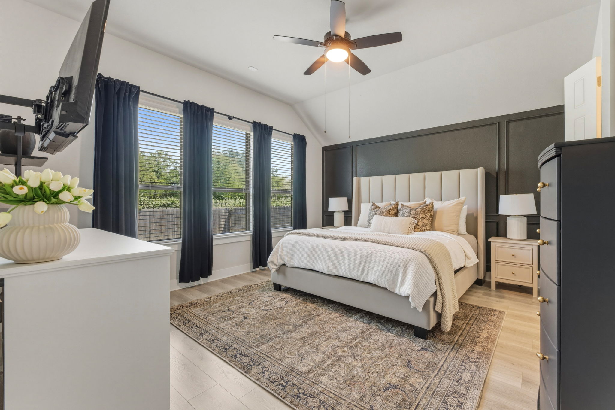 4505 Post Loop Round Rock, TX 78681 - Photo 21 of 40 Bedroom featuring ceiling fan, light wood-type flooring, lofted ceiling, and a decorative wall