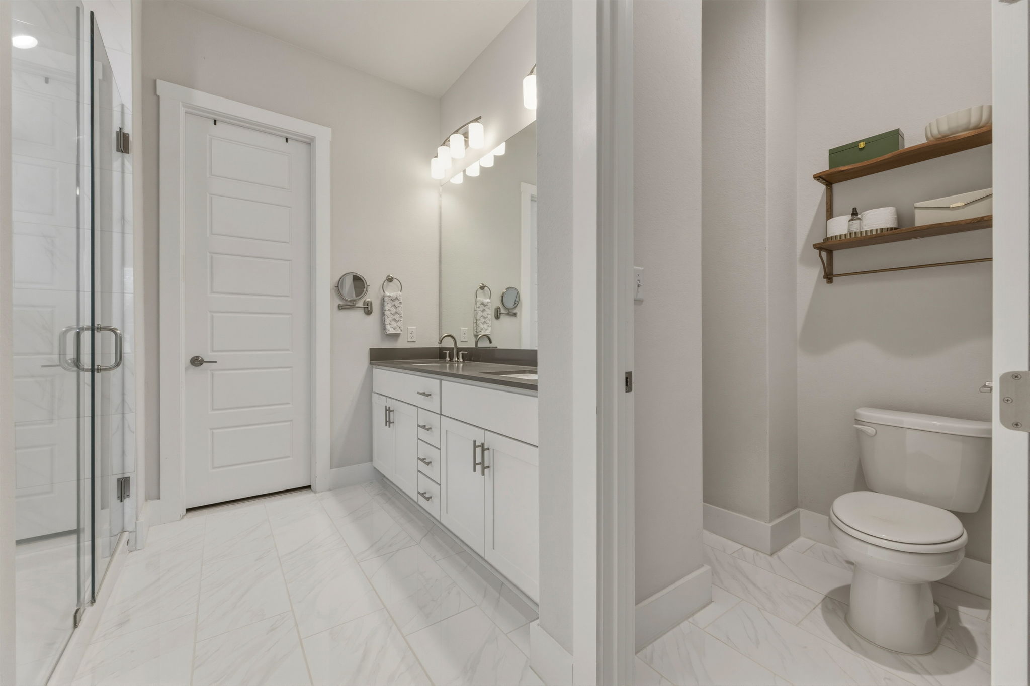 4505 Post Loop Round Rock, TX 78681 - Photo 24 of 40 Bathroom featuring light marble finish flooring, double vanity, and a shower stall
