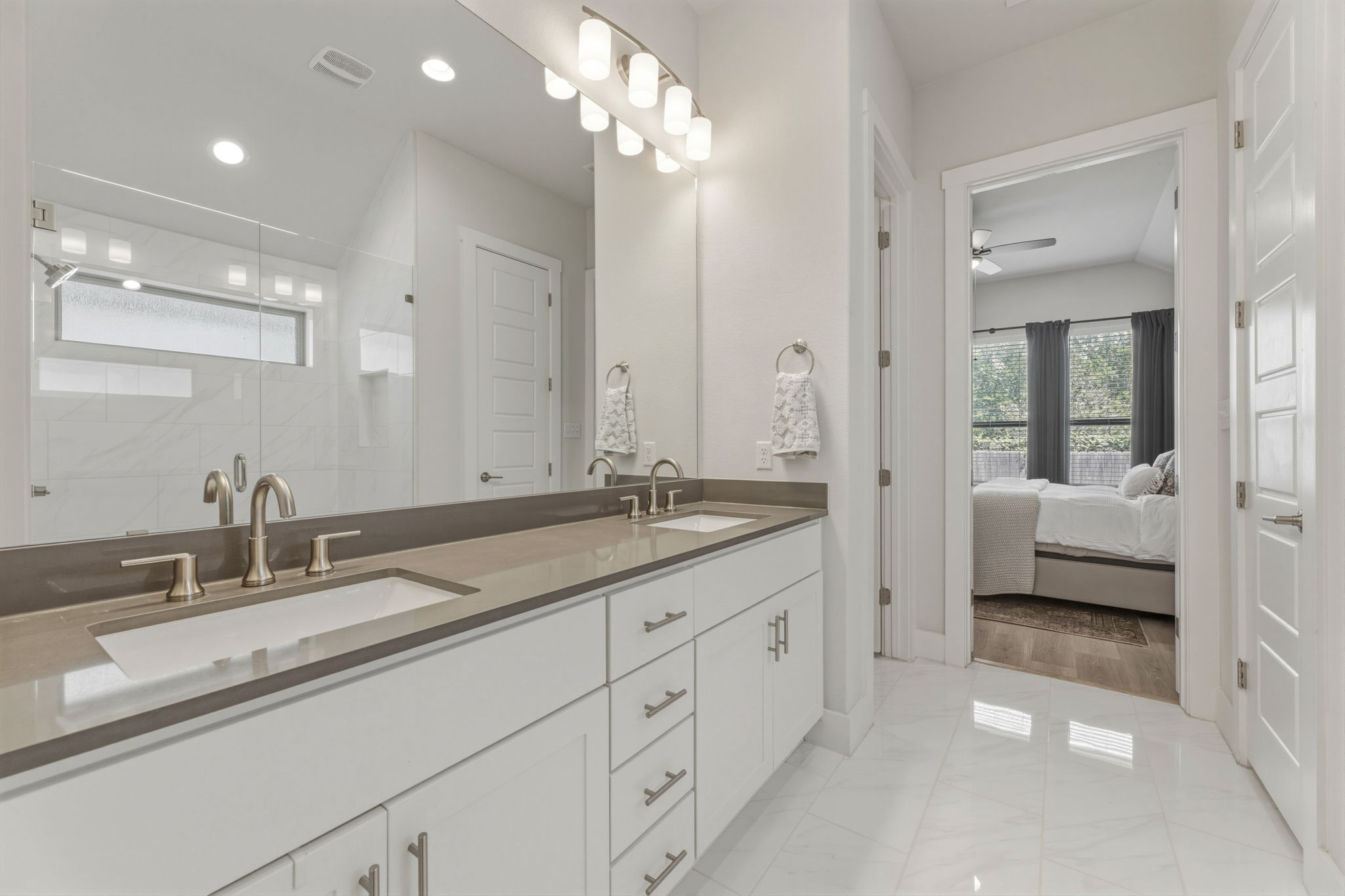 4505 Post Loop Round Rock, TX 78681 - Photo 25 of 40 Ensuite bathroom with double vanity, an enclosed shower, light marble finish flooring, and ceiling fan