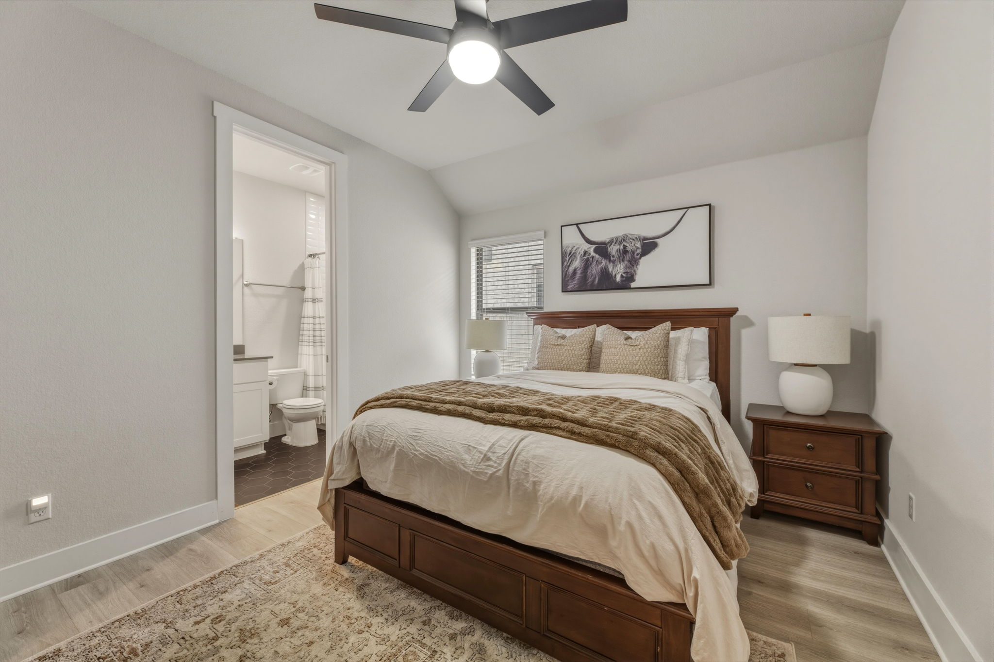 4505 Post Loop Round Rock, TX 78681 - Photo 27 of 40 Bedroom featuring lofted ceiling, light wood-style floors, a ceiling fan, and ensuite bathroom