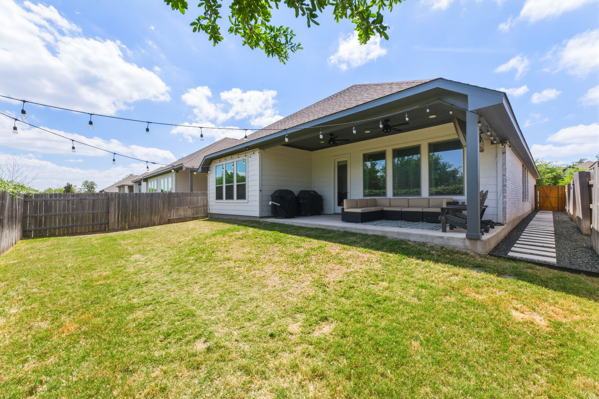4505 Post Loop Round Rock, TX 78681 - Photo 36 of 40 Rear view of house with ceiling fan, a fenced backyard, an outdoor living space, and a patio