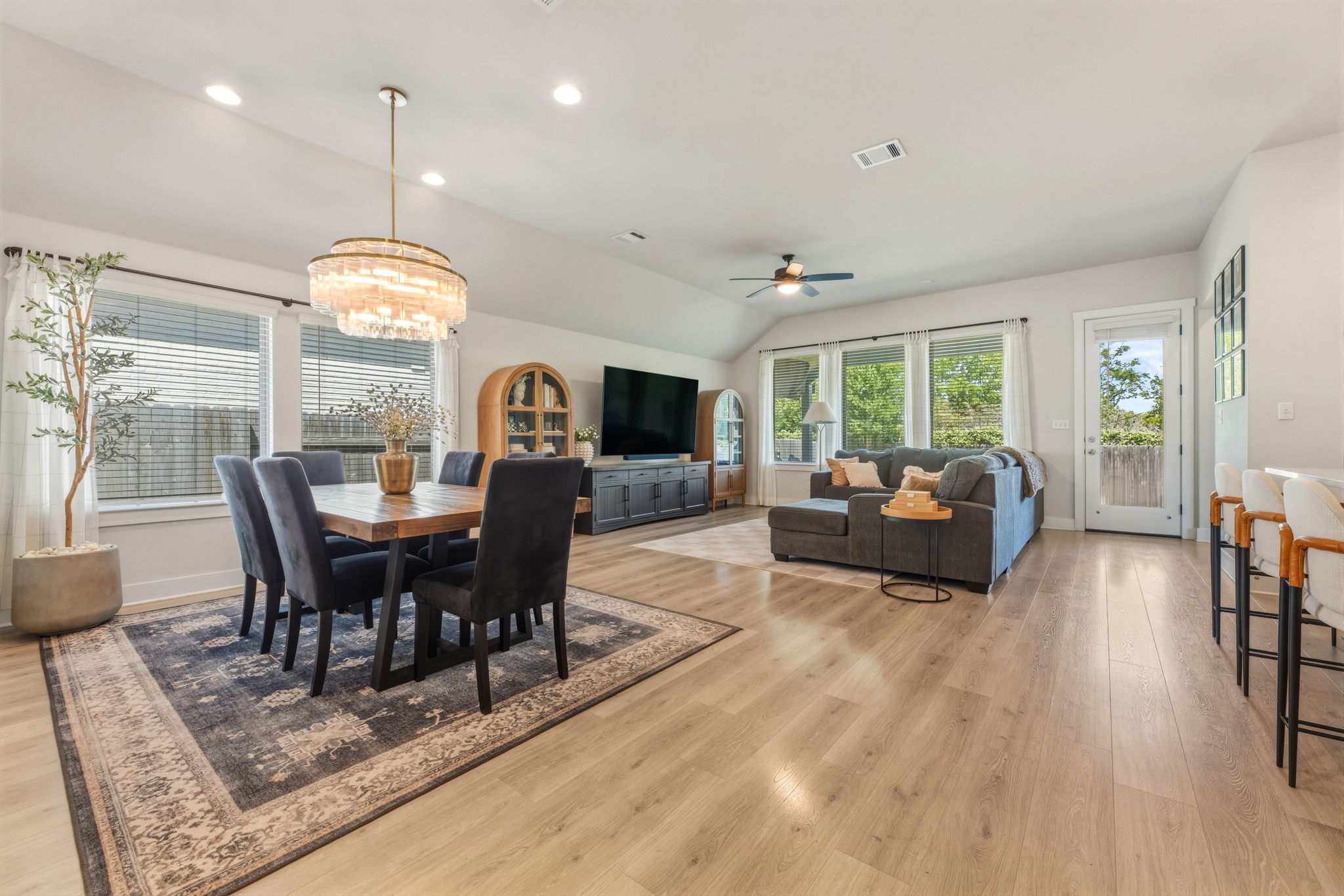 4505 Post Loop Round Rock, TX 78681 - Photo 8 of 40 Dining space featuring lofted ceiling, light wood-style floors, ceiling fan, suspended lighting, and healthy amount of natural light