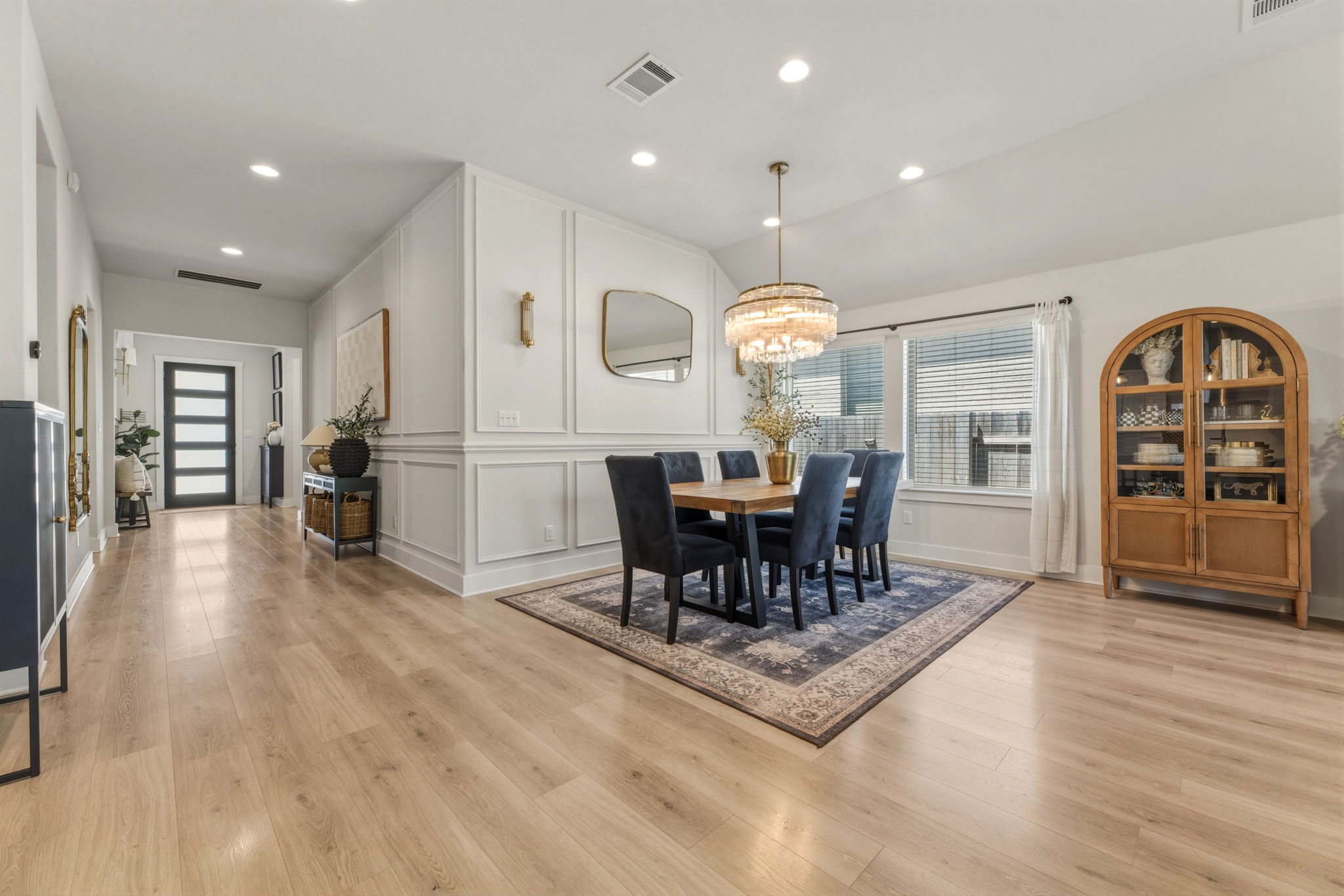 4505 Post Loop Round Rock, TX 78681 - Photo 9 of 40 Dining space with a decorative wall, light wood-style flooring, and hanging lights