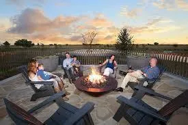 a roof deck with couches and wooden floor