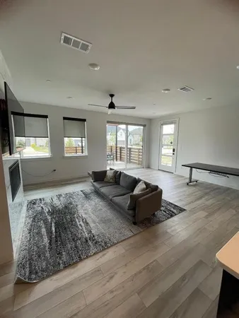 a living room with furniture window and wooden floor