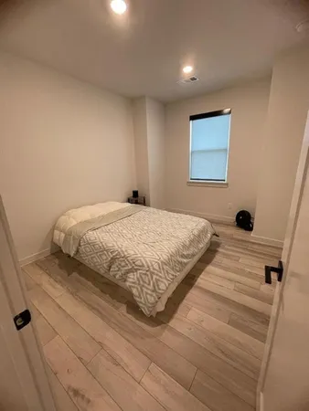 a bedroom with a bed and a large mirror
