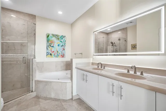 a bathroom with a sink a large mirror and a shower