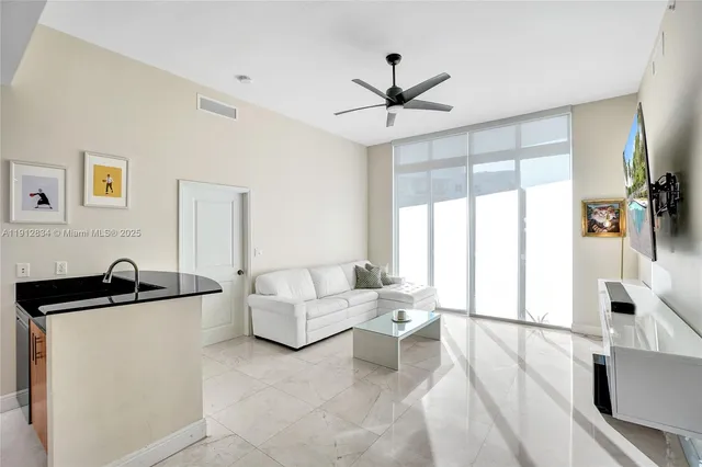 a living room with furniture and a large window