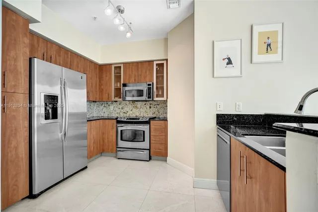 a kitchen with stainless steel appliances granite countertop a stove and a refrigerator