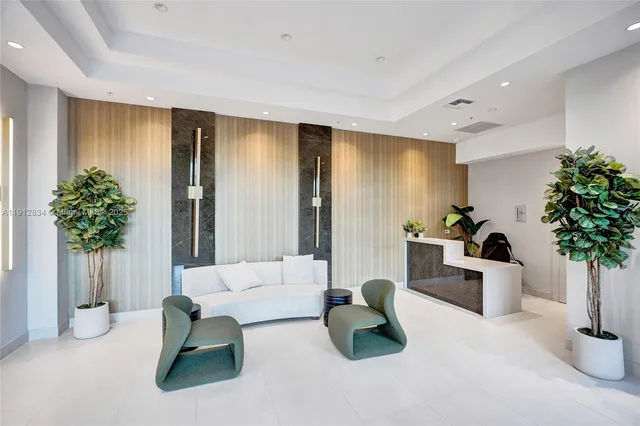 a living room with furniture and potted plant