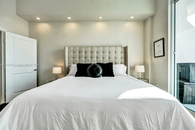 a bedroom with a bed and a large mirror