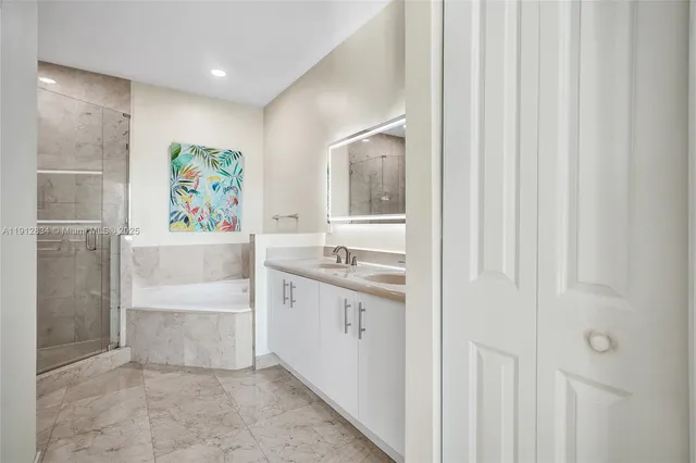 a bathroom with a sink a vanity and a shower