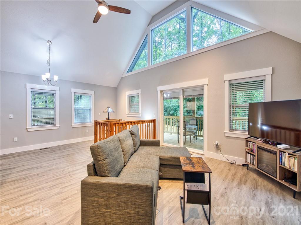 90 Ash Drive Maggie Valley, NC 28751 - Photo 14 of 24 a living room with furniture a flat screen tv and a large window