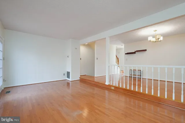 a view of an empty room and wooden floor