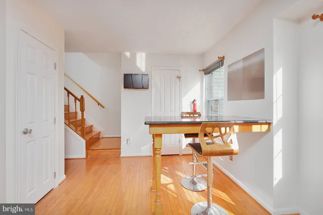 a view of kitchen and dining room with wooden floor