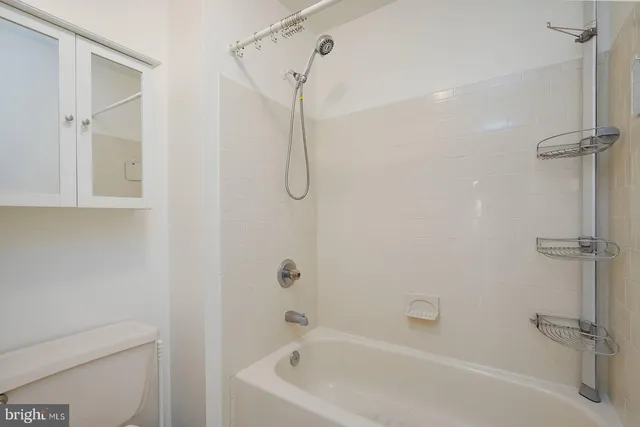 a white bath tub with a shower