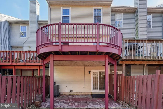 a view of a house with wooden fence