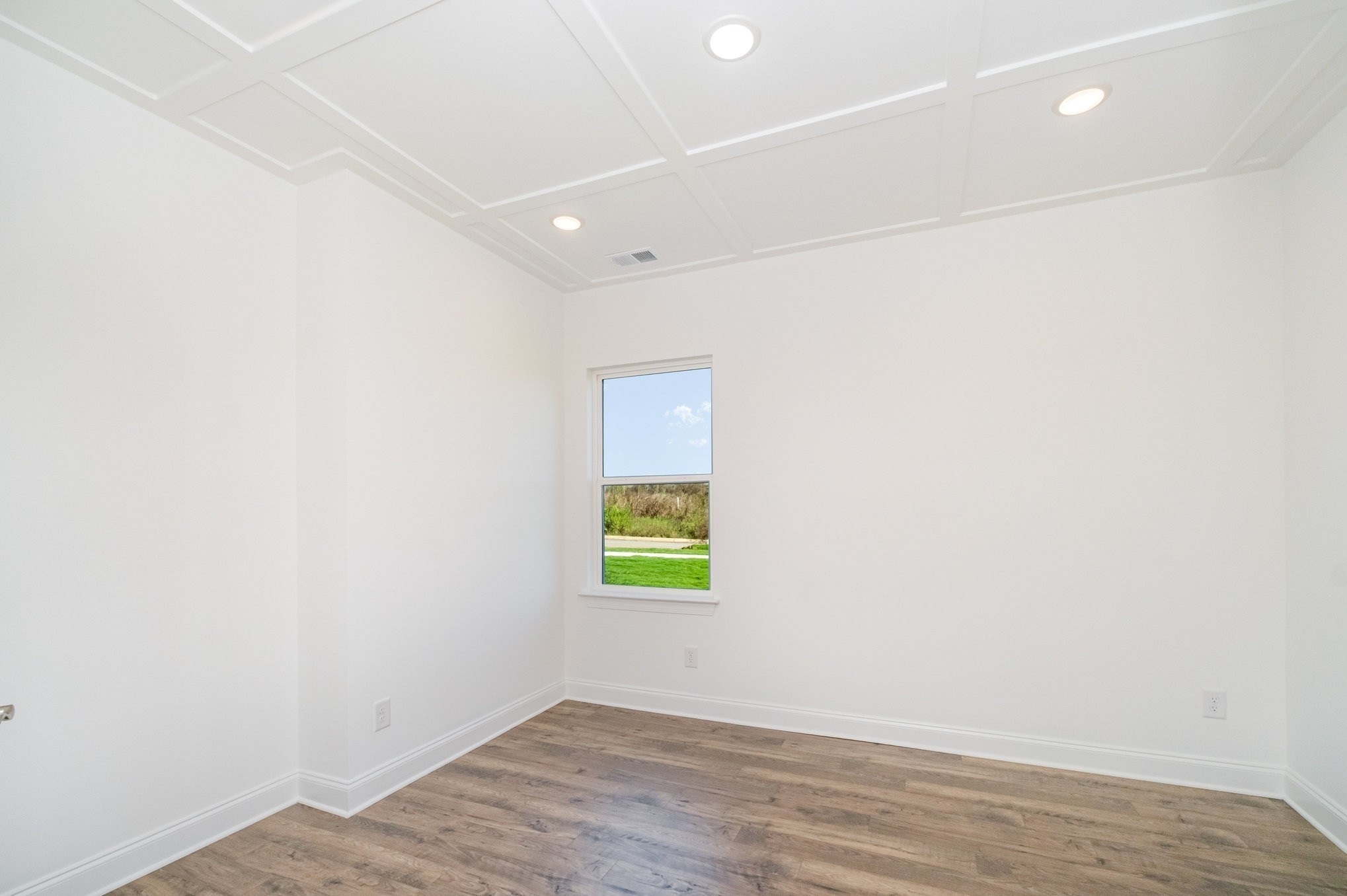 6417 Waymeet Dr Spring Hill Spring Hill, TN 37174 - Photo 13 of 26 a view of an empty room with wooden floor and a window