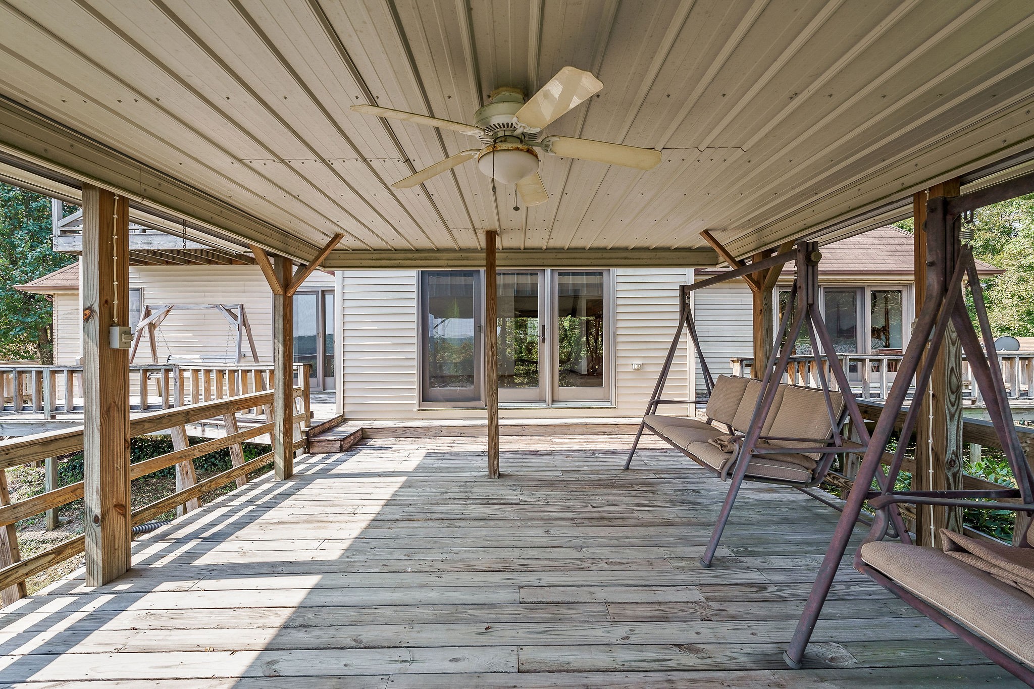 309 Cedar Hill Road Celina, TN 38551 - Photo 14 of 60 a view of a porch with wooden floor and iron stairs