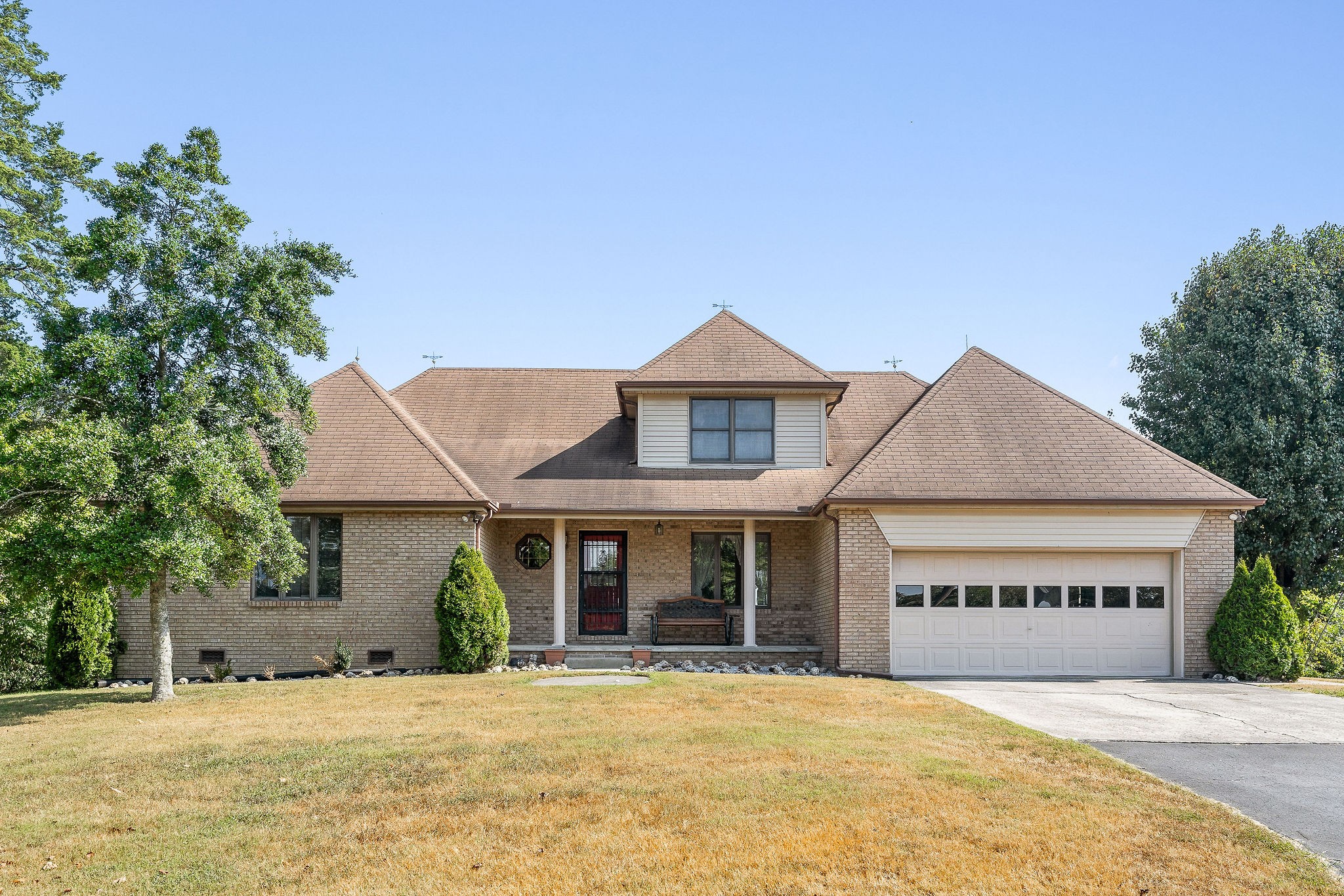 309 Cedar Hill Road Celina, TN 38551 - Photo 2 of 60 a front view of a house with a garden and porch