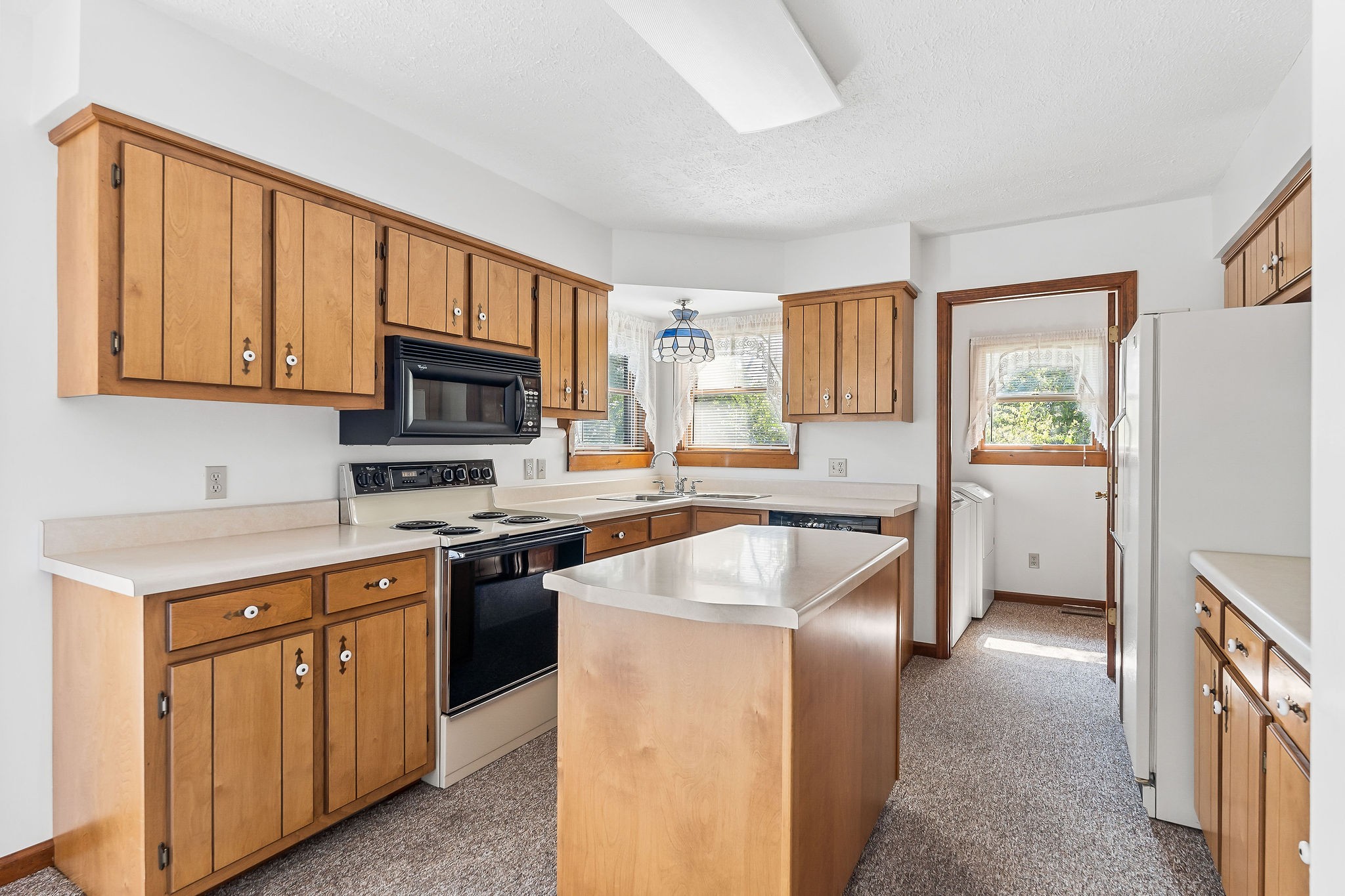 309 Cedar Hill Road Celina, TN 38551 - Photo 26 of 60 a kitchen with stainless steel appliances granite countertop a refrigerator stove microwave and sink