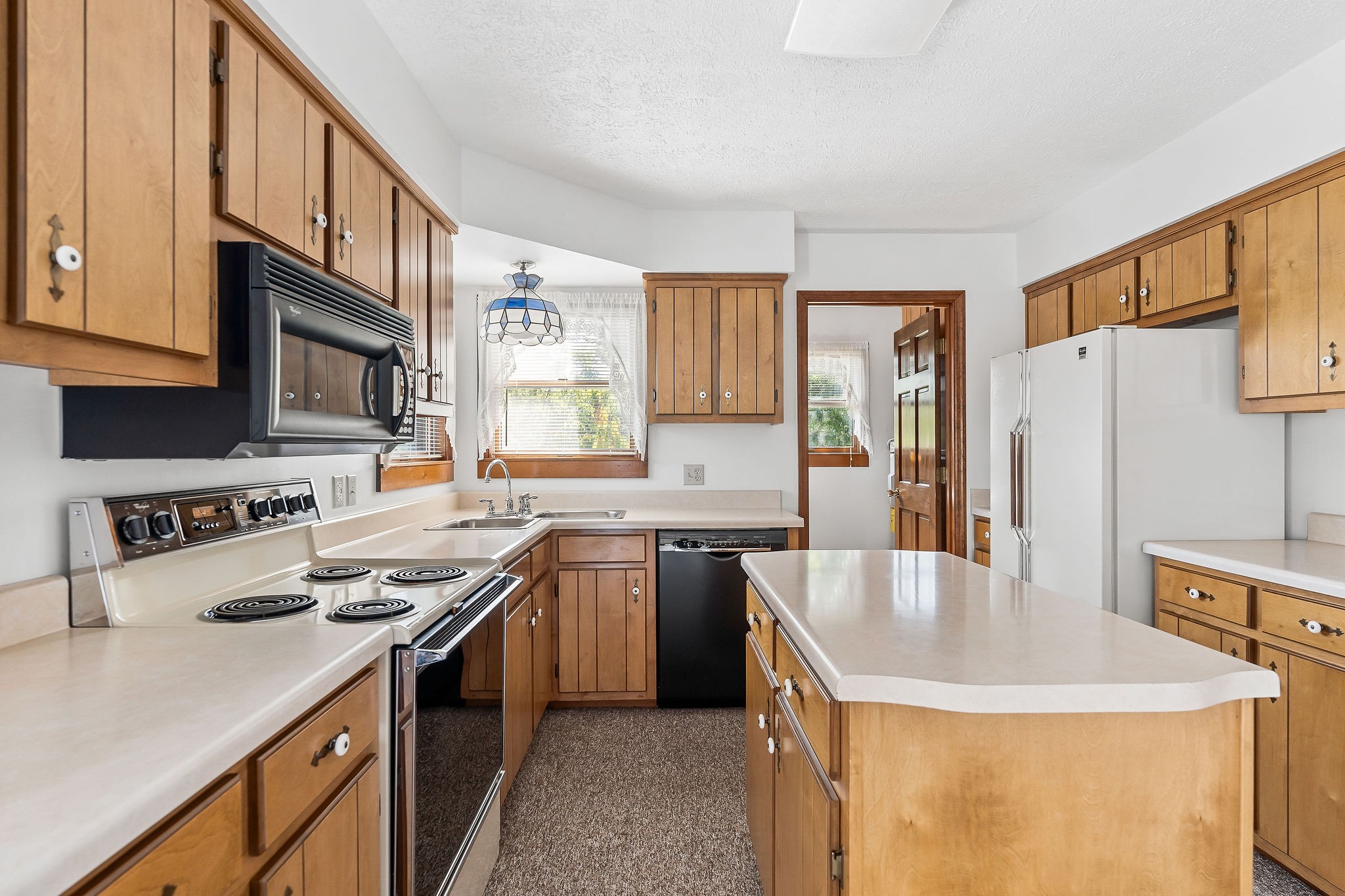 309 Cedar Hill Road Celina, TN 38551 - Photo 27 of 60 a kitchen with stainless steel appliances granite countertop a sink stove and refrigerator