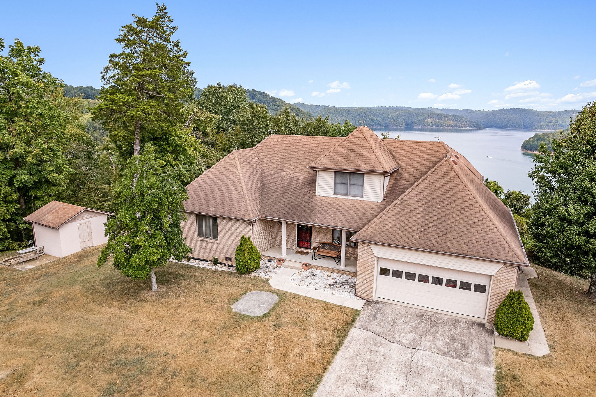 309 Cedar Hill Road Celina, TN 38551 - Photo 3 of 60 a view of a house with backyard and a garden