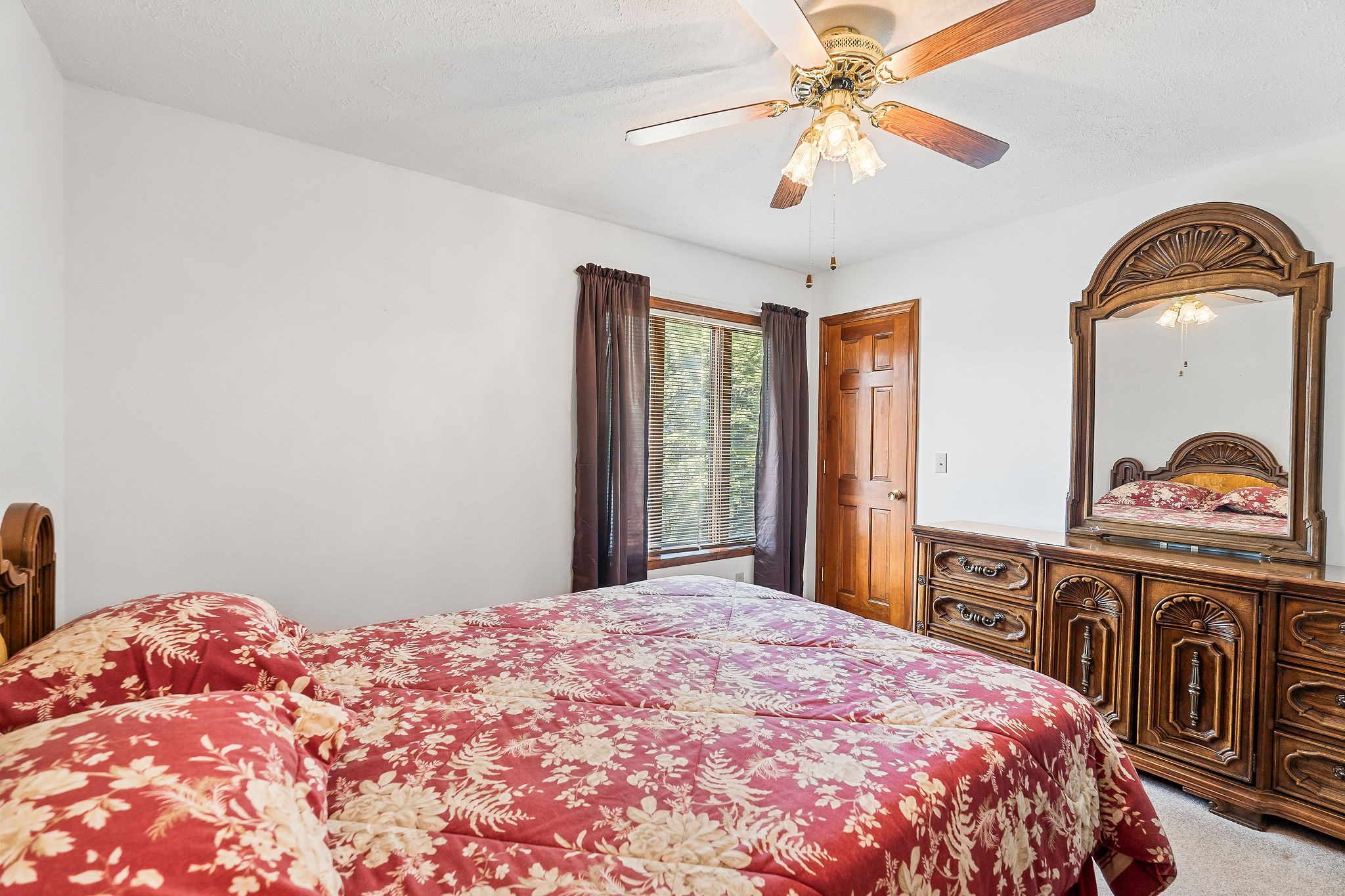 309 Cedar Hill Road Celina, TN 38551 - Photo 31 of 60 a bedroom with a bed and a chandelier